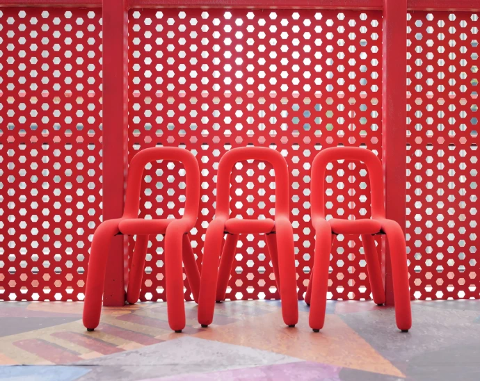 a group of red chairs sitting next to each other